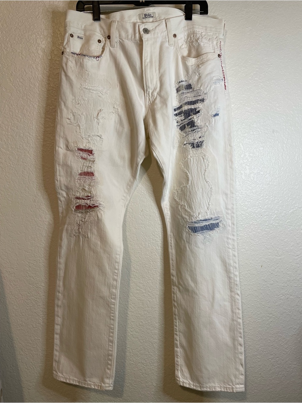 Polo by Ralph Lauren Men’s White Straight-Leg American flag distressed jeans.